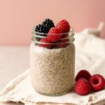 A jar of chia seed pudding with fresh berries, a healthy and easy-to-make breakfast or snack from a nutritional coaching plan.