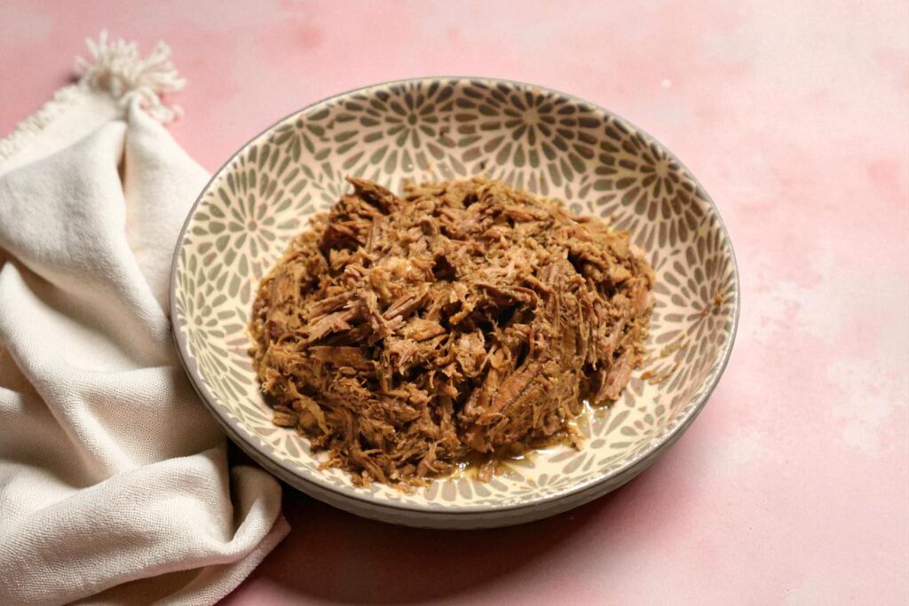 A bowl of shredded beef, a high-protein, low-carb recipe from a nutritional coaching plan.